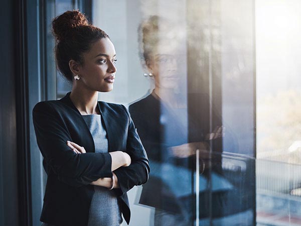 a woman standing in front of a window