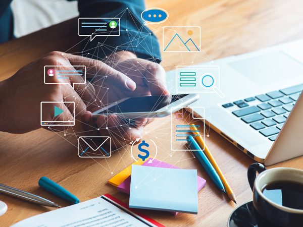 person sitting at desk using cellphone