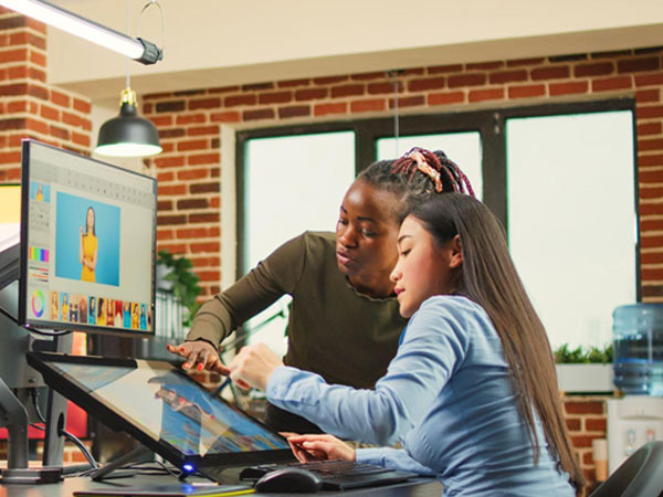 two girls looking at monitor
