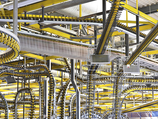 Cross-crossing automated conveyor belts inside a production facility