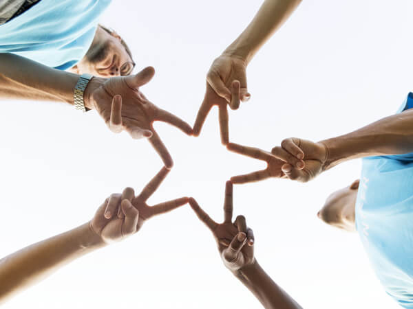 people making a star with their fingers