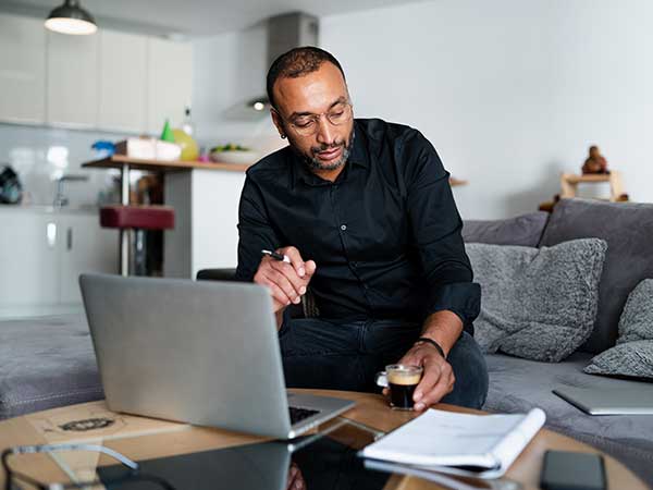 man working at his laptop in his living room