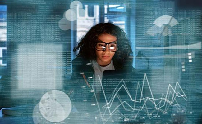 lady looking at monitor with a techical background surrounding her