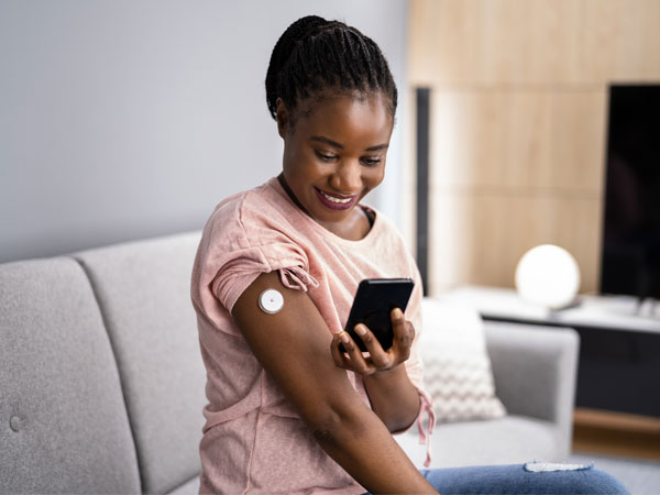A woman checking her blood glucose level on her phone