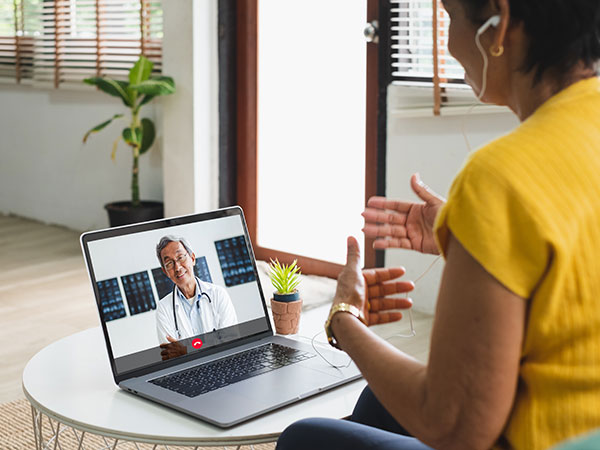 A woman meeting with her doctor via telehealth