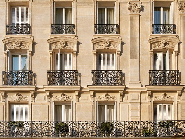 photo of a building in Paris with three floors of ornate balconies