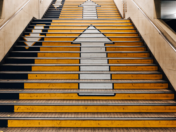subway stairs with arrows pointing up and down for direction