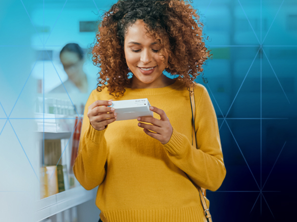A woman holding a small rectangluar object