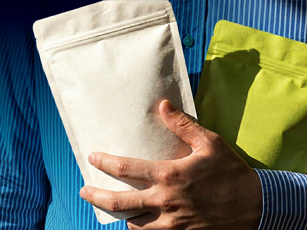 Hands holding two packaged products.