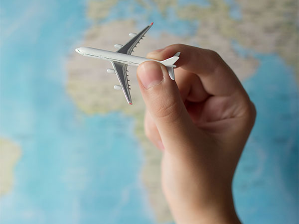 Hand shown flying a toy airplane