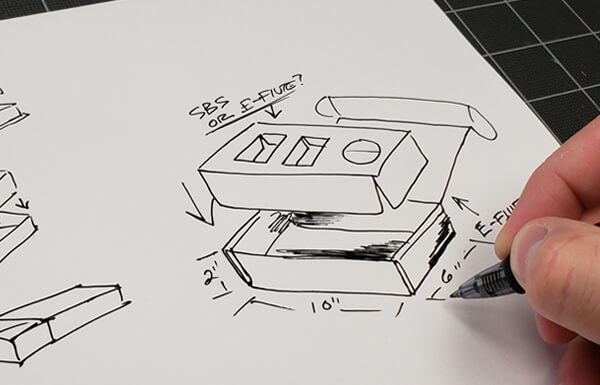 someone sketching packaging designs.