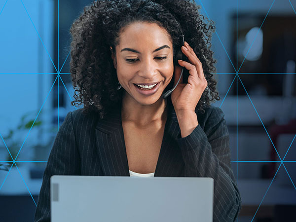 Woman with a headset looking at her laptop