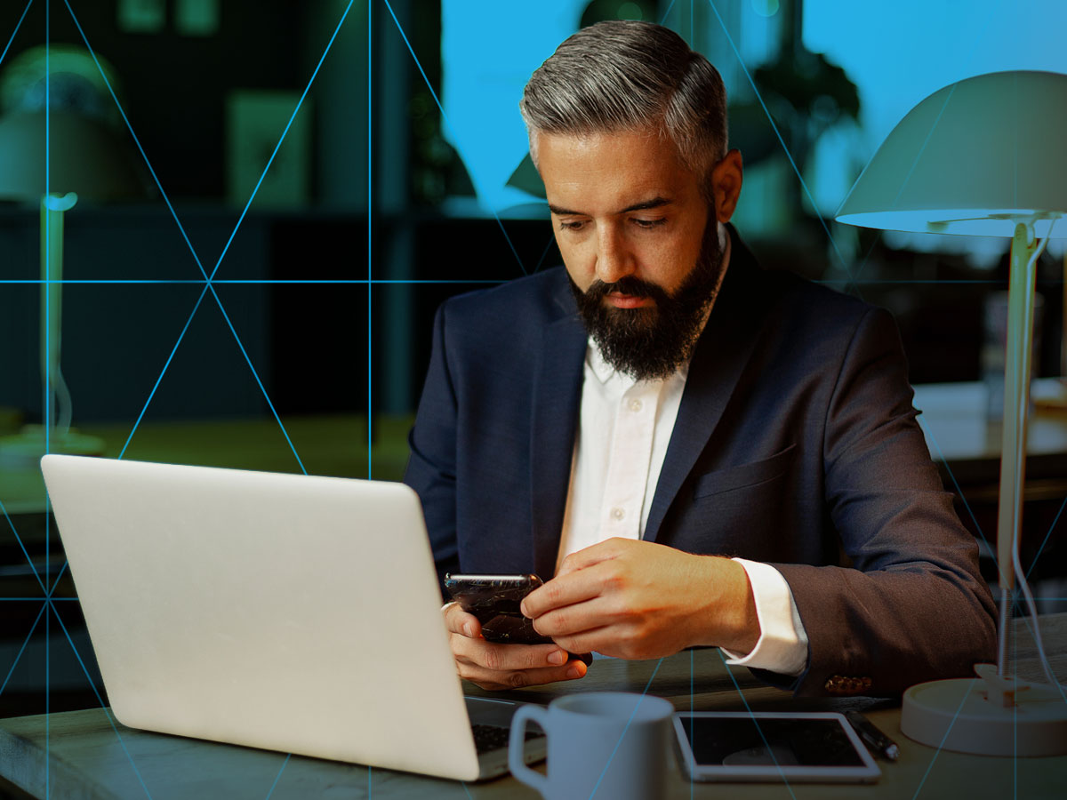 man working with different types of communication devices