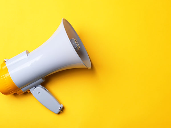 photograph of a megaphone against a bright yellow background