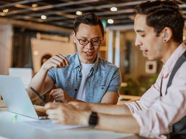 two men collaborating at work