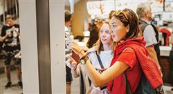 teen girls ordering food at a kiosk