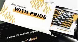 various marketing collateral for Towson University including socks and a pin in a Flex Mailer