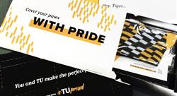 various marketing collateral for Towson University including socks and a pin in a Flex Mailer