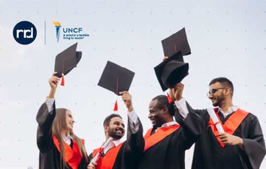 graduates with graduation caps and logos