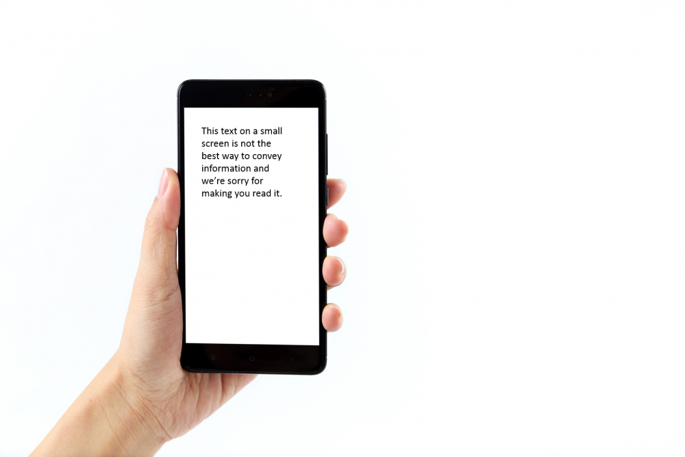 image of a hand holding a cellphone with small text on the screen as an example of keeping imagery and text separate when it comes to marketing materials