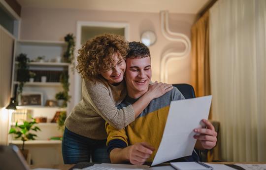 Mom and son celebrate good news college admission via mail