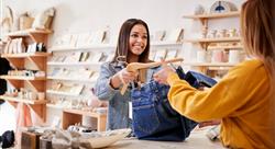 Female Sales Assistant In Independent Clothing And Gift Store Serving Female Customer