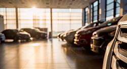 New cars in a sunlit dealer showroom