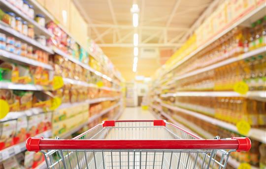 grocery cart rolling down an aisle in a grocery store