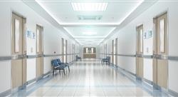Long, bright and empty hospital corridor with doors and chairs