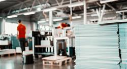 Picture of printing shop interior. Selective focus on pile of sheets