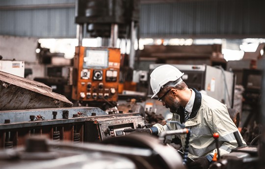 Engineer working in industrial warehouse environment
