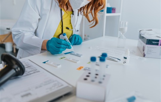 General practitioner doing medical sample rapid diagnostic test at examination room