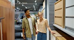 young couple shopping for furniture in furniture store