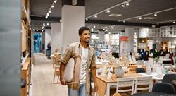 Man carrying folding chair to shop counter