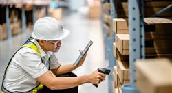 Warehouse workers use scanner checking and scan the barcode of stock inventory to keep storage in a 