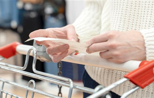 a girl with a shopping receipt in her hands