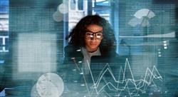 Young woman looking at computer screen, surrounded by visuals of statistics