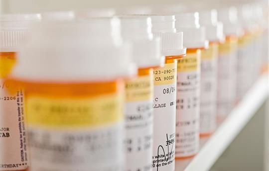 close-up of orange prescription bottles lined up