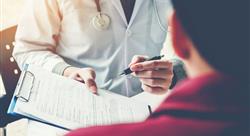 doctor pen and handing clipboard with forms over to patient in office setting