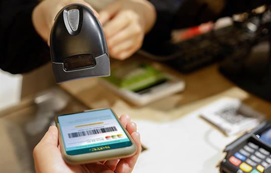 Hand-held scanner reading digital coupon