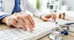 The hands of a female doctor typing on a keyboard
