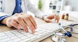 The hands of a female doctor typing on a keyboard