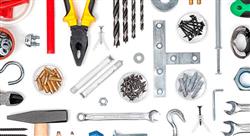various household tools arranged on a white surface