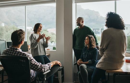 Diverse designers discussing a project during an office meeting