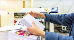 Workers hands manipulating envelopes for mailing