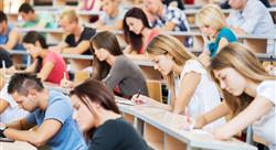 college students in a lecture hall taking notes