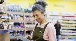 grocery clerk using a tablet