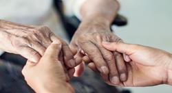Close up of hands of helping elderly hands for in-home care.