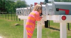 Child checking the mailbox for a direct mail marketing piece from RRD