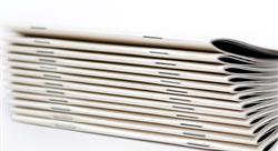 stack of white magazines with saddle stitch binding